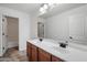 Bathroom featuring a double vanity, modern fixtures, and neutral tile flooring at 12217 W Planada Ln, Sun City, AZ 85373
