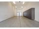 Spacious garage with epoxy flooring, overhead lighting, and custom gray cabinetry at 12217 W Planada Ln, Sun City, AZ 85373