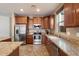 Spacious kitchen featuring stainless steel appliances, granite counters, and ample cabinet space at 12217 W Planada Ln, Sun City, AZ 85373