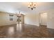 Bright living area features a ceiling fan, tile flooring, backyard access, and a seamless flow to other rooms at 12217 W Planada Ln, Sun City, AZ 85373