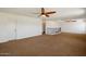 Spacious loft area with brown carpeting, ceiling fans, and abundant natural light at 12217 W Planada Ln, Sun City, AZ 85373