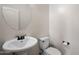 This powder room offers a pedestal sink, toilet, and essential fixtures for convenience at 12217 W Planada Ln, Sun City, AZ 85373