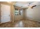 Inviting room featuring tile floors, neutral walls, a ceiling fan and natural light from two windows at 12217 W Planada Ln, Sun City, AZ 85373