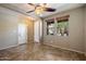 Bright room featuring tile floors, neutral walls, a ceiling fan and natural light from two windows at 12217 W Planada Ln, Sun City, AZ 85373