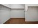 Spacious walk-in closet with built-in shelving and brown carpeting at 12217 W Planada Ln, Sun City, AZ 85373