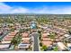 Scenic aerial shot of homes in a residential area, featuring blue swimming pools and lush greenery at 12745 W Monte Vista Rd, Avondale, AZ 85392