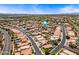Serene aerial view of a suburban neighborhood with palm-lined streets, and community parks at 12745 W Monte Vista Rd, Avondale, AZ 85392