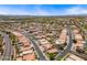Expansive aerial view of a residential neighborhood with pools and tree-lined streets under a clear blue sky at 12745 W Monte Vista Rd, Avondale, AZ 85392
