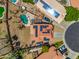 Aerial view of a house with a private pool, solar panels, and well-maintained landscaping at 12745 W Monte Vista Rd, Avondale, AZ 85392