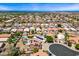 Expansive aerial view of the neighborhood with lush landscaping, tile roofs and community streets at 12745 W Monte Vista Rd, Avondale, AZ 85392