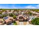 Aerial view of community showcasing various properties, lush trees, landscaping and solar panels at 12745 W Monte Vista Rd, Avondale, AZ 85392