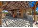 Backyard features a covered patio, desert landscaping, string lights and a privacy fence at 12745 W Monte Vista Rd, Avondale, AZ 85392