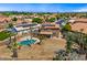 Aerial shot of a well-maintained backyard featuring a pool, solar panels, pergola and mature landscaping at 12745 W Monte Vista Rd, Avondale, AZ 85392