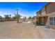 Large backyard with desert landscaping, a pool, covered patio, and exterior view of home at 12745 W Monte Vista Rd, Avondale, AZ 85392