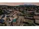 Aerial shot of backyard with a pool, covered patio, desert landscaping and a view of the mountains at 12745 W Monte Vista Rd, Avondale, AZ 85392