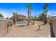 Spacious backyard featuring an in-ground pool, desert landscaping, and mature palm trees at 12745 W Monte Vista Rd, Avondale, AZ 85392