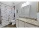 Well-lit bathroom features a granite countertop, framed mirror and Paris-themed shower curtain at 12745 W Monte Vista Rd, Avondale, AZ 85392