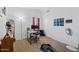 Bedroom with neutral carpet, desk, and a large window providing natural light at 12745 W Monte Vista Rd, Avondale, AZ 85392