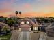 Charming two-story home with a well-manicured lawn and an inviting entrance during sunset at 12745 W Monte Vista Rd, Avondale, AZ 85392