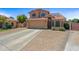 Inviting two-story home featuring a well-manicured lawn and a spacious three-car garage at 12745 W Monte Vista Rd, Avondale, AZ 85392