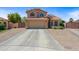Charming home features a tile roof, two-car garage, and mature trees for a welcoming curb appeal at 12745 W Monte Vista Rd, Avondale, AZ 85392