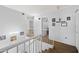 Bright hallway features white walls and railings leading to bedrooms and other living spaces at 12745 W Monte Vista Rd, Avondale, AZ 85392