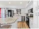 Modern kitchen with white cabinetry, granite countertops, stainless steel appliances, and hardwood flooring at 12745 W Monte Vista Rd, Avondale, AZ 85392