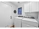 Bright laundry room with machines, cabinets, and exterior access, enhancing convenience at 12745 W Monte Vista Rd, Avondale, AZ 85392
