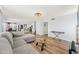 Spacious living room with hardwood floors, neutral paint, modern lighting and an open layout to the kitchen at 12745 W Monte Vista Rd, Avondale, AZ 85392