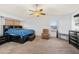 A spacious main bedroom featuring a ceiling fan, large windows, and carpeted floors at 12745 W Monte Vista Rd, Avondale, AZ 85392