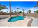 Backyard pool featuring an in-ground pool, mature landscaping, and patio with outdoor umbrella at 12745 W Monte Vista Rd, Avondale, AZ 85392