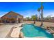 Backyard featuring a large in-ground pool, mature landscaping, and a covered patio at 12745 W Monte Vista Rd, Avondale, AZ 85392