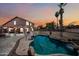 Backyard featuring a large in-ground pool, patio, pergola, and tropical landscaping at 12745 W Monte Vista Rd, Avondale, AZ 85392