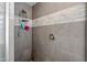 Detailed view of a modern shower with gray tile and sleek fixtures at 12745 W Monte Vista Rd, Avondale, AZ 85392