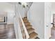 Bright entryway with a staircase featuring carpeted steps and a white handrail at 12745 W Monte Vista Rd, Avondale, AZ 85392