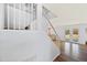 Bright staircase leading to a living area with outdoor views through French doors and hardwood-style flooring at 12745 W Monte Vista Rd, Avondale, AZ 85392