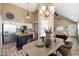 Charming dining room adjacent to the kitchen features a decorative chandelier and stylish brick flooring at 20818 N 21St Dr, Phoenix, AZ 85027