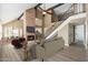 Inviting living room boasts a brick fireplace, beamed ceilings, and an open staircase at 20818 N 21St Dr, Phoenix, AZ 85027