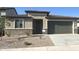 Single-story home features stucco siding, brick accents, desert landscaping, and a two-car garage at 25342 W Bowker St, Buckeye, AZ 85326