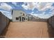 Spacious backyard featuring block fence, and an unfinished yard with room for customization at 2557 E Music Mountain Ave, Apache Junction, AZ 85119