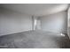 Spacious bedroom featuring neutral carpet, light gray walls, and ample natural light from a large window at 2557 E Music Mountain Ave, Apache Junction, AZ 85119