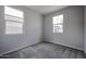 Bedroom with neutral gray walls, carpet, and natural light from two windows at 2557 E Music Mountain Ave, Apache Junction, AZ 85119