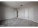 Bedroom featuring neutral walls, plush carpet, closet, and a doorway leading to the rest of the home at 2557 E Music Mountain Ave, Apache Junction, AZ 85119