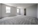 Bright bedroom with neutral carpet, windows, and light gray walls, creating a cozy and inviting space at 2557 E Music Mountain Ave, Apache Junction, AZ 85119