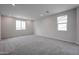 This bonus room features neutral walls, plush carpet, and two windows providing ample natural light at 2557 E Music Mountain Ave, Apache Junction, AZ 85119
