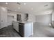 Spacious kitchen with white cabinets, granite countertops and island, and stainless steel appliances at 2557 E Music Mountain Ave, Apache Junction, AZ 85119