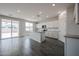 Bright, open-concept kitchen featuring white cabinetry, granite counters, and stainless steel appliances at 2557 E Music Mountain Ave, Apache Junction, AZ 85119