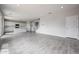 Open-concept living room with wood-look tile flooring, connecting to the kitchen and staircase, offers a spacious layout at 2557 E Music Mountain Ave, Apache Junction, AZ 85119
