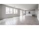 Bright living room boasts wood-look tile, flows into the kitchen with white cabinets, and has ample natural light at 2557 E Music Mountain Ave, Apache Junction, AZ 85119