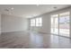 Bright living room features light gray walls, wood-look tile flooring, and natural light from large windows at 2557 E Music Mountain Ave, Apache Junction, AZ 85119